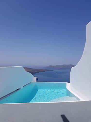 a view of a pool of water from a window at Adamant Suites in Fira