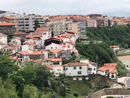 a group of houses on a hill in a city at Pensión Basagoiti in Getxo