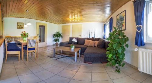 a living room with a couch and a table at Ferienwohnung am Schneeberg in Titisee-Neustadt