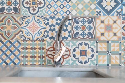 a sink with a faucet in a bathroom with tiles at My Loft 4 You Ruzafa Style III in Valencia
