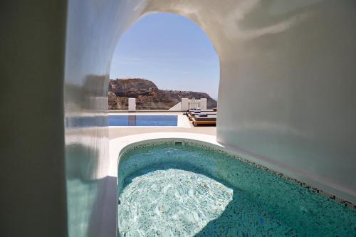 a view of a swimming pool from inside a house at Volcano View by Caldera Collection in Fira