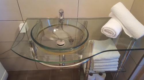 a glass table with a sink in a bathroom at Holiday Home Adna in Bihać