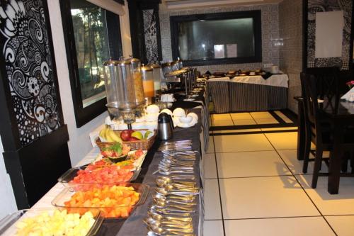 a buffet line with fruit on it in a hotel room at Liwa - The Transit Hotel, Bengaluru in Bengaluru