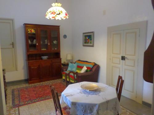 a living room with a table and a chair at Casa Millenovecento in Brindisi