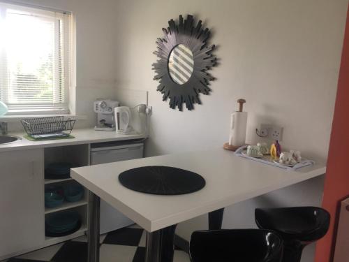 a kitchen with a table with chairs and a mirror at Hillcrest House Self Catering Apartments in Donegal