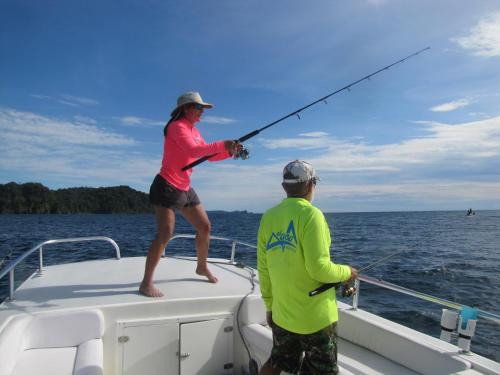 a man and a woman fishing on a boat at Ecolodge el Arca Bahia Solano in Bahía Solano