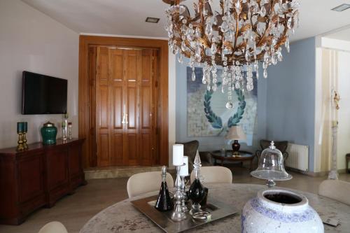 a dining room with a table and a chandelier at Esperia Boutique Hotel in Agrinion