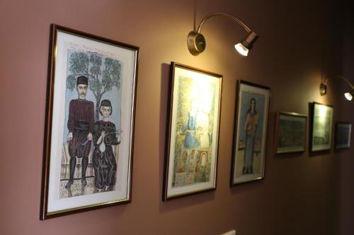 a row of pictures hanging on a wall at Esperia Boutique Hotel in Agrinion