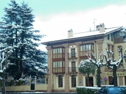 a building with a tree in front of it at Palacio Azcárate Hotel in Ezcaray