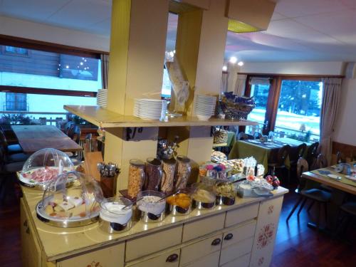 a buffet in a restaurant with a lot of food at Hotel Ermitage Verbier in Verbier