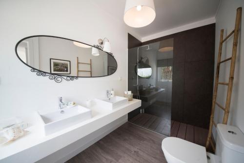 a bathroom with two sinks and a mirror at Quinta do Meco - Beach & Nature in Aldeia do Meco
