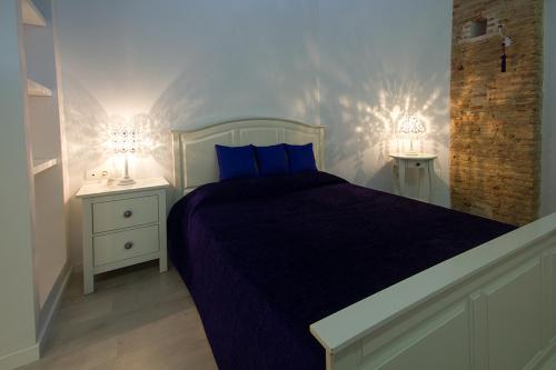 a bedroom with a purple bed and two night stands at Total Valencia Elegance in Valencia