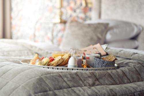 a tray of food on top of a bed at Statt Hassleholm BW Signature Collection in Hässleholm