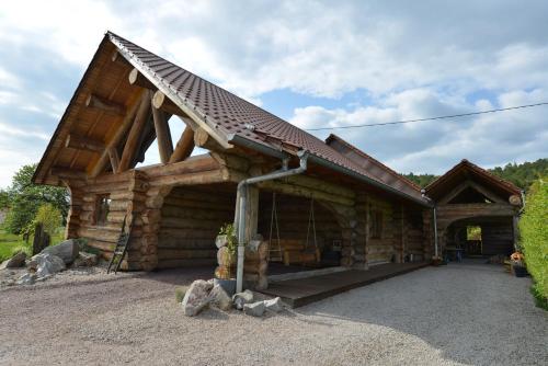 a log cabin with a gambrel roof at Le Chalet de Lyne in Erckartswiller