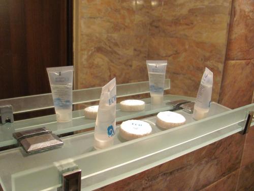 a display case in a bathroom with towels and toiletries at Lucky Travelers Room in Tbilisi City