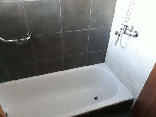 a white bath tub in a bathroom with a shower at Departamento Meliades in El Bolsón