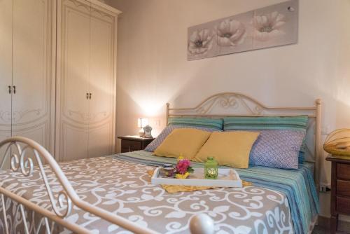 a bedroom with a bed with a tray on it at Casa brillocco Castellabate in Montecorice