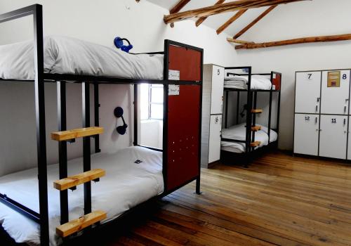 a room with three bunk beds in it at Intro Hostels Cusco in Cusco