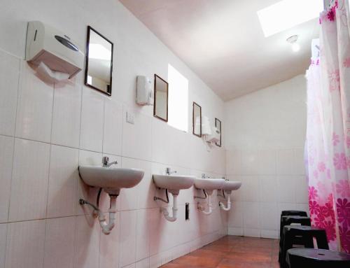 a bathroom with two sinks and a mirror at Intro Hostels Cusco in Cusco