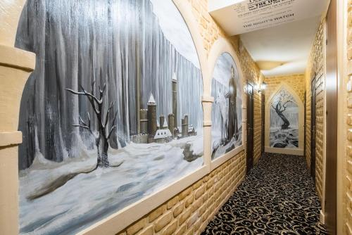 a hallway with paintings on the walls at Winterfell Paveletskaya in Moscow
