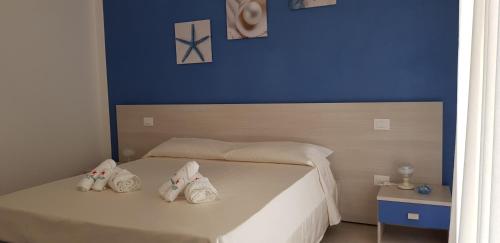 a bedroom with a bed with towels on it at Stella Marina Agropoli in Agropoli