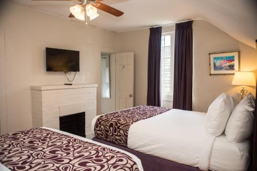 a hotel room with a bed and a fireplace at Inn on Ursulines, a French Quarter Guest Houses Property in New Orleans