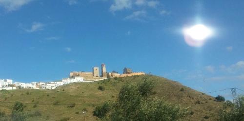 a city on top of a hill with a building at Casa Encina - Encinasola Turismo Rural. in Alora