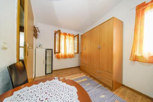 a living room with a table and a refrigerator at Holiday Home Jere in Postira