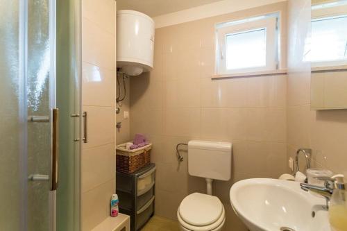 a bathroom with a toilet and a sink at Fresh & spacious studio in Dubrovnik