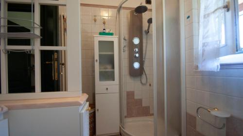 a bathroom with a shower and a sink and a tub at Villa Gadry in Tavullia