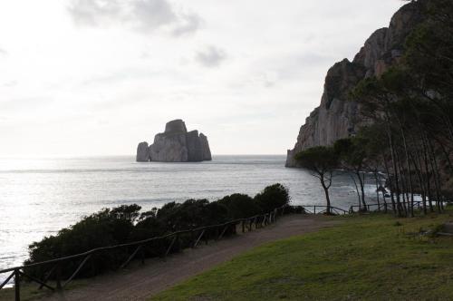 a large rock in the ocean next to the ocean at Nel verde del Villaggio - Casetta Celeste in Gonnesa