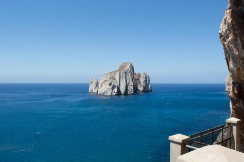 a view of a large rock formation in the ocean at Nel verde del Villaggio - Casetta Celeste in Gonnesa