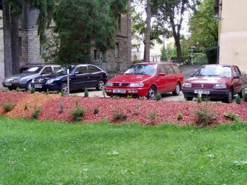 a group of three cars parked in a parking lot at Wellness Penzion U Muzea in Liberec