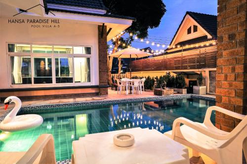a swimming pool with a swan in a house at Hansa Paradise Hill Pool Villa in Nong Prue