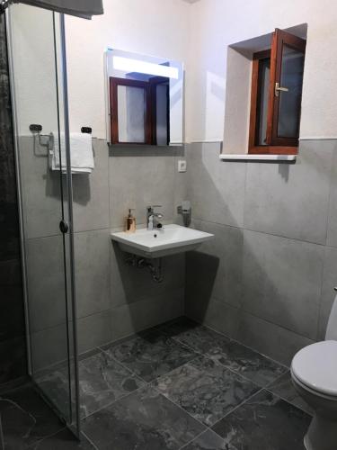 a bathroom with a sink and a shower at Stone house 264 in Kotor
