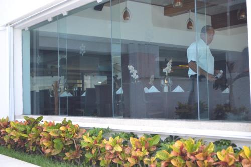 a man standing in the window of a building at Ocean View Condo in Cancún