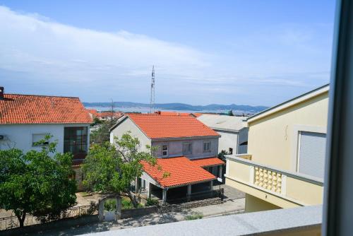 a view of a group of buildings with orange roofs at Apartments Aurora in Zadar