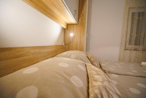 a bedroom with a bed and a window at Apartments Aurora in Zadar