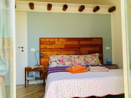 a bedroom with a bed with a wooden headboard at Gò Gò House in Palermo