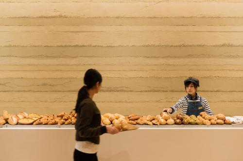 two people standing in front of a counter with potatoes at Shirahama Key Terrace Hotel Seamore in Shirahama