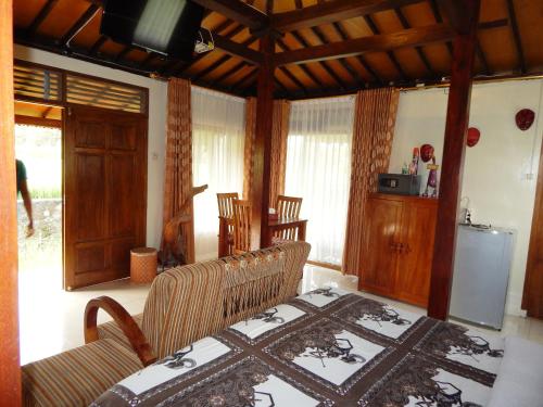 a room with a couch and a table with a rug at Alamanda Family Villas, Pool & Local Tours in Yogyakarta