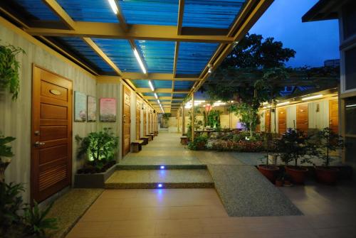 a hallway of a building with plants and a ceiling at Long Shan Hotel in Jiaoxi