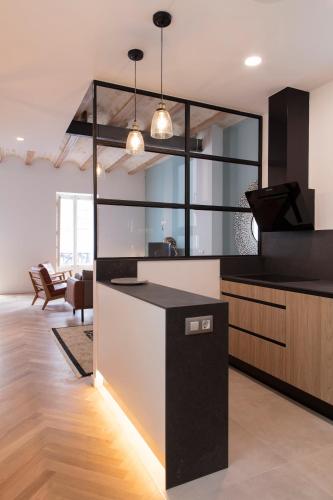 a kitchen with a black and white counter top at FLORIT FLATS - Chic and Central in a lively but quiet area All walking distance in Valencia