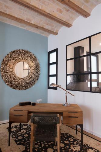 a desk with a lamp and a mirror on a wall at FLORIT FLATS - Chic and Central in a lively but quiet area All walking distance in Valencia