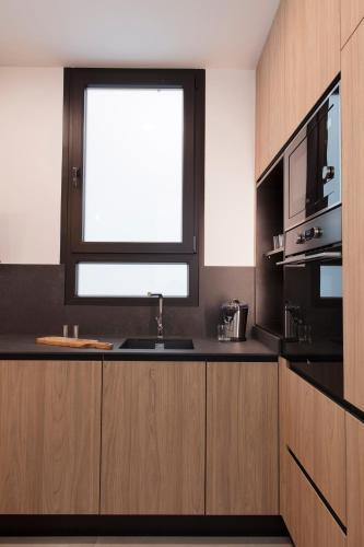 a kitchen with a sink and a window at FLORIT FLATS - Chic and Central in a lively but quiet area All walking distance in Valencia