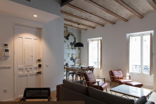 a living room with a couch and a table at FLORIT FLATS - Chic and Central in a lively but quiet area All walking distance in Valencia