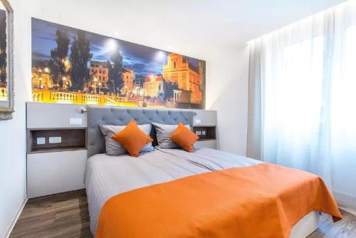 a bedroom with a large bed with an orange blanket at ★ Exclusive Central Apartment ★ FREE Garage ★ in Ljubljana