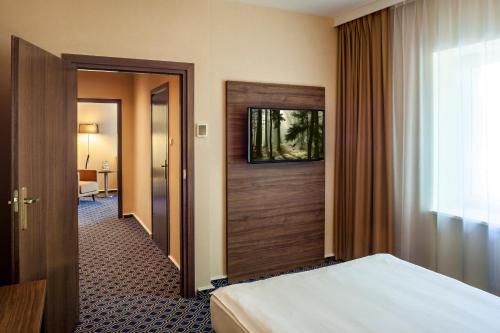 Postel nebo postele na pokoji v ubytování Warmiński Hotel & Conference
