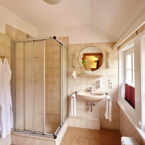 a bathroom with a shower and a sink at Landhaus Haverbeckhof in Niederhaverbeck