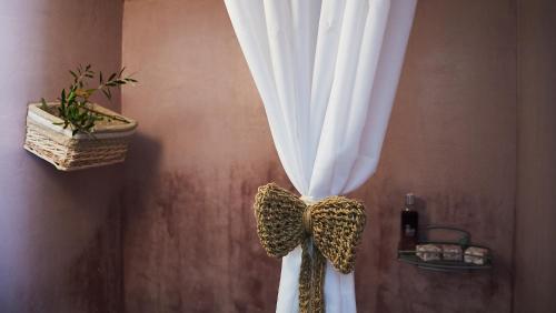a curtain tied with a bow in a room at Moorea Country Houses in Petalidhion